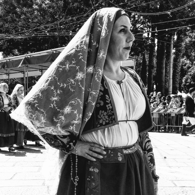 image of a woman in traditional sardinian costume in the annual st efisio parade
